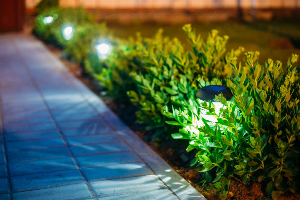 Lighted walkway with hardscaping and landscaping by Evolving Landscapes in Lee's Summit