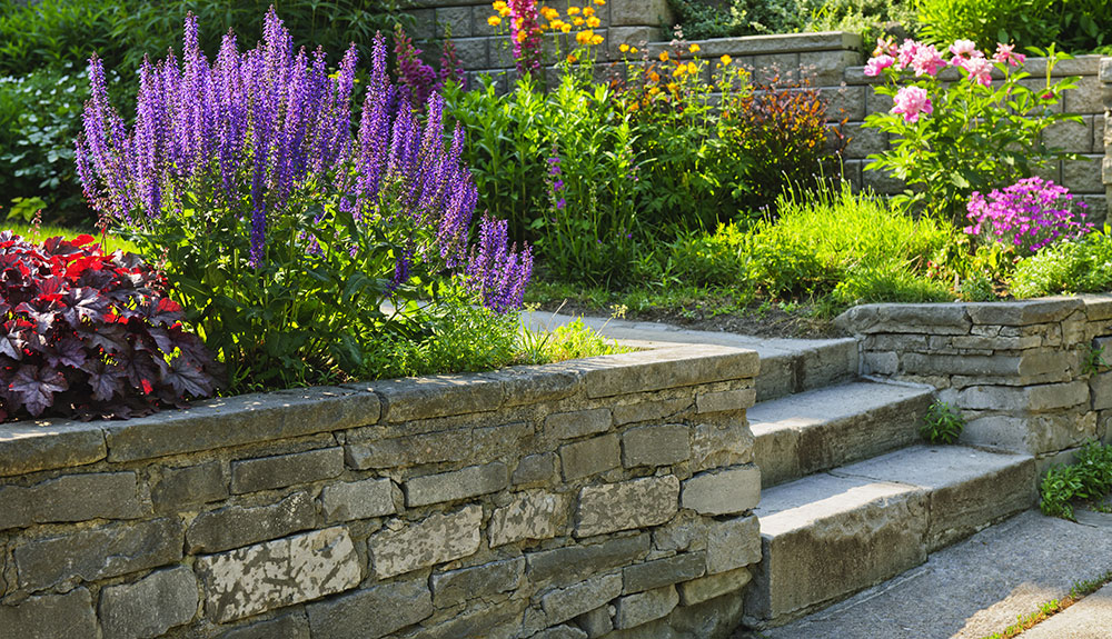 Stone retaining wall and staircase by Evolving Landscapes in Lee's Summit, MO